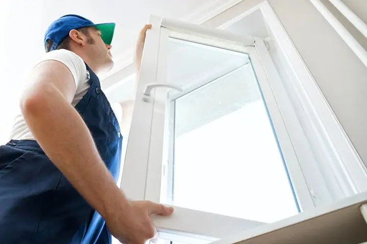 Technician fixing the window door