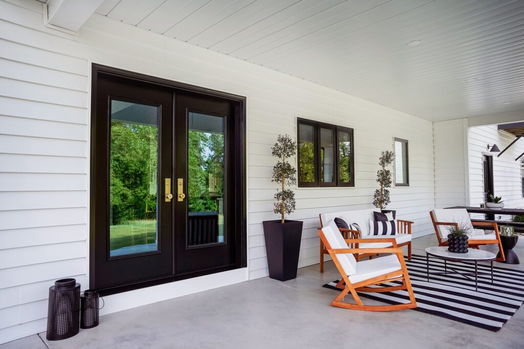 Modern porch with furniture and black accents.