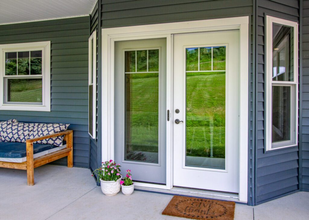 Patio with glass doors and potted plants.