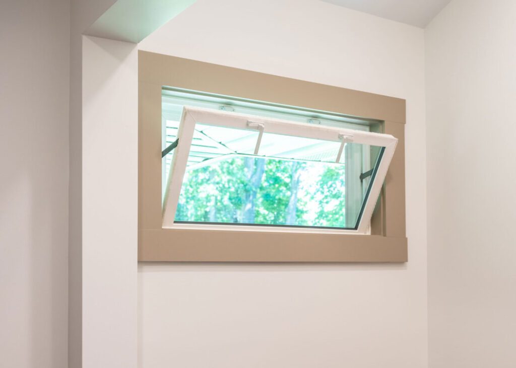Awning window partially open with outdoor view.