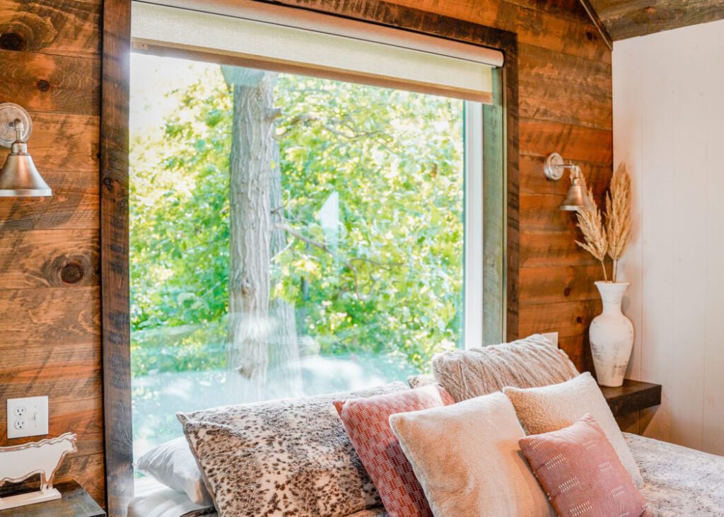 Cozy bedroom with large window view.